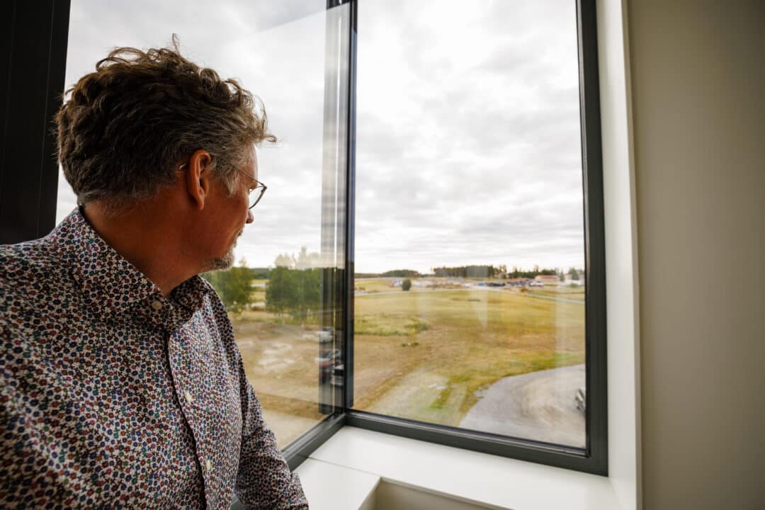 Thomas looking out over Boden Business Park through the window.