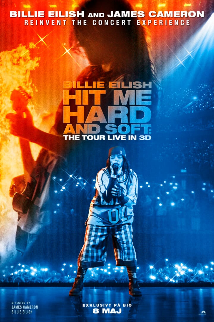 Promotional concert poster with a singer center stage, orange flames left, blue lights right, bold text reading 'HIT ME HARD' and '8 MAJ' at bottom.