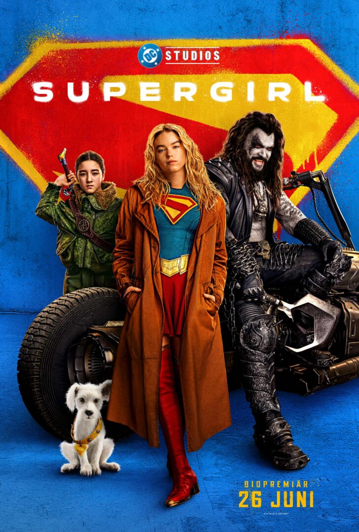 Promotional poster for Supergirl showing three heroes posed before a bold red-yellow emblem on a blue wall, with a small white dog in front.